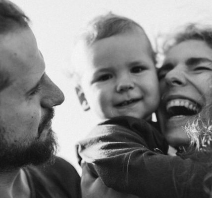 A happy family enjoying a heartfelt moment together in a black-and-white setting.