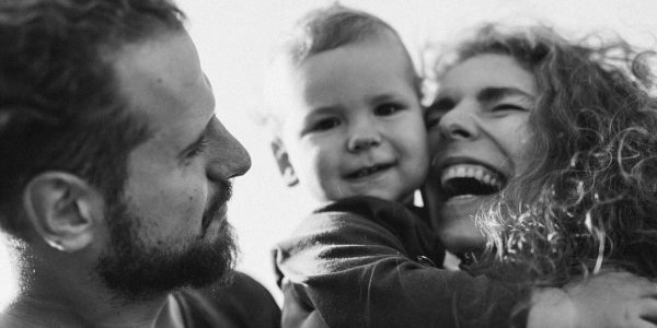 A happy family enjoying a heartfelt moment together in a black-and-white setting.